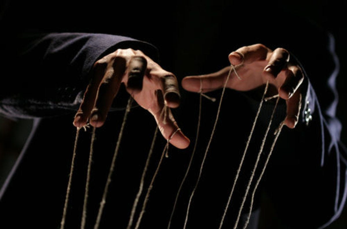 Hands with strings connected to each finger, suggesting they are controlling puppets.