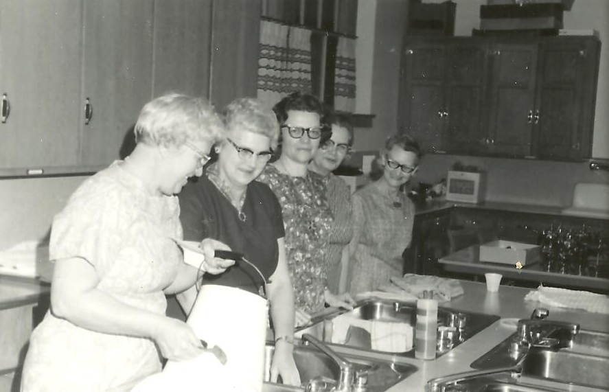 Church ladies cooking in 1972 from https://dinnerisserved1972.com/2012/09/19/church-lady-cookbook-casserole-challenge-cock-a-doodle-casserole/